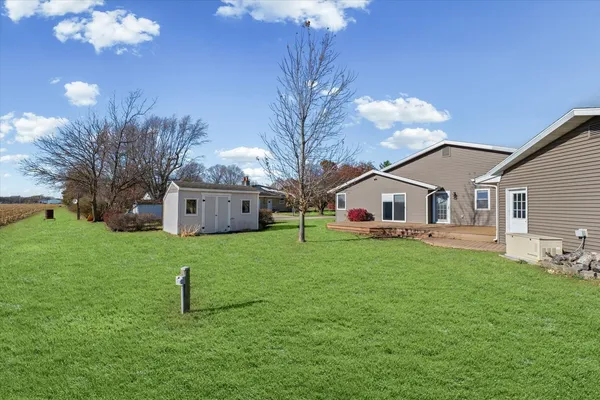 a front view of house with yard and tree s