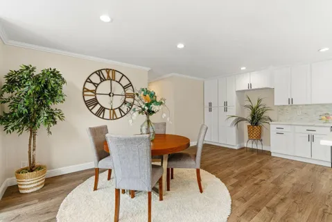 a view of a dining room with furniture and wooden floor
