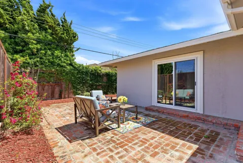 a view of a patio with table and chairs and potted plants