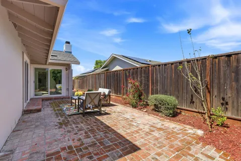 a patio with table and chairs