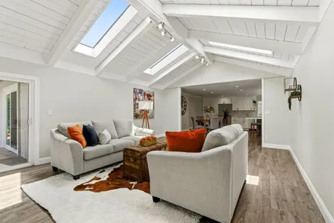 a living room with furniture and a wooden floor