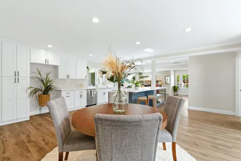 a dining room with furniture and wooden floor