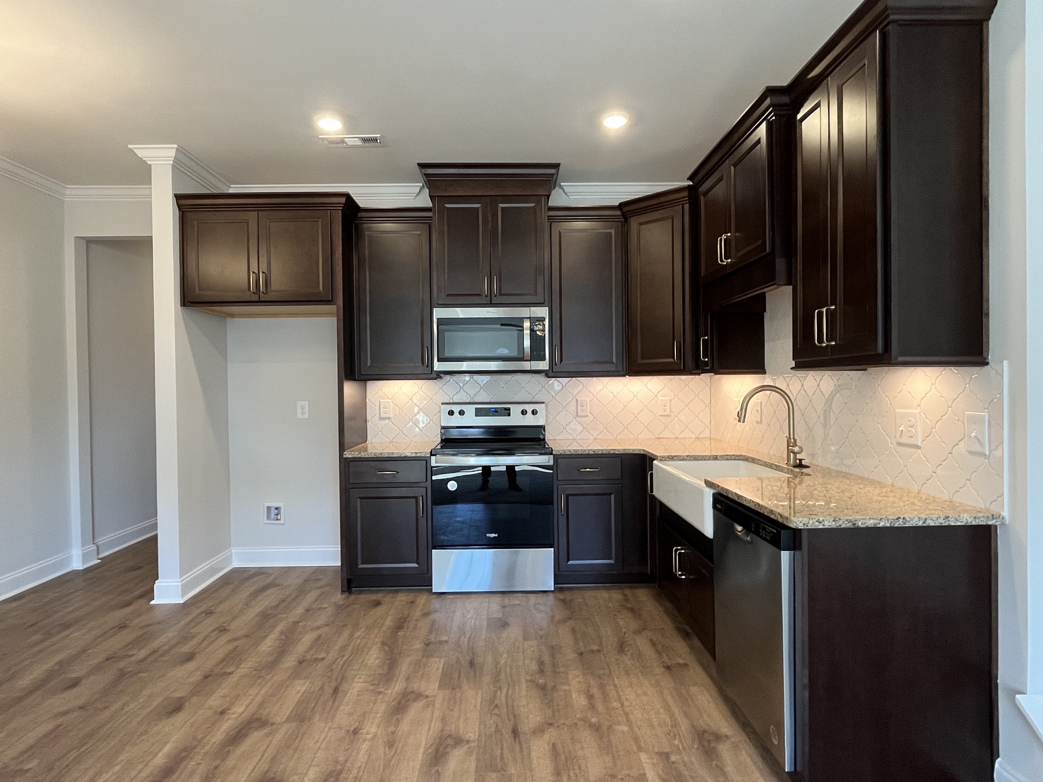 3267 Tasker Drive Antioch, TN 37013 - Photo 6 of 44 a kitchen with granite countertop stainless steel appliances and wooden cabinets