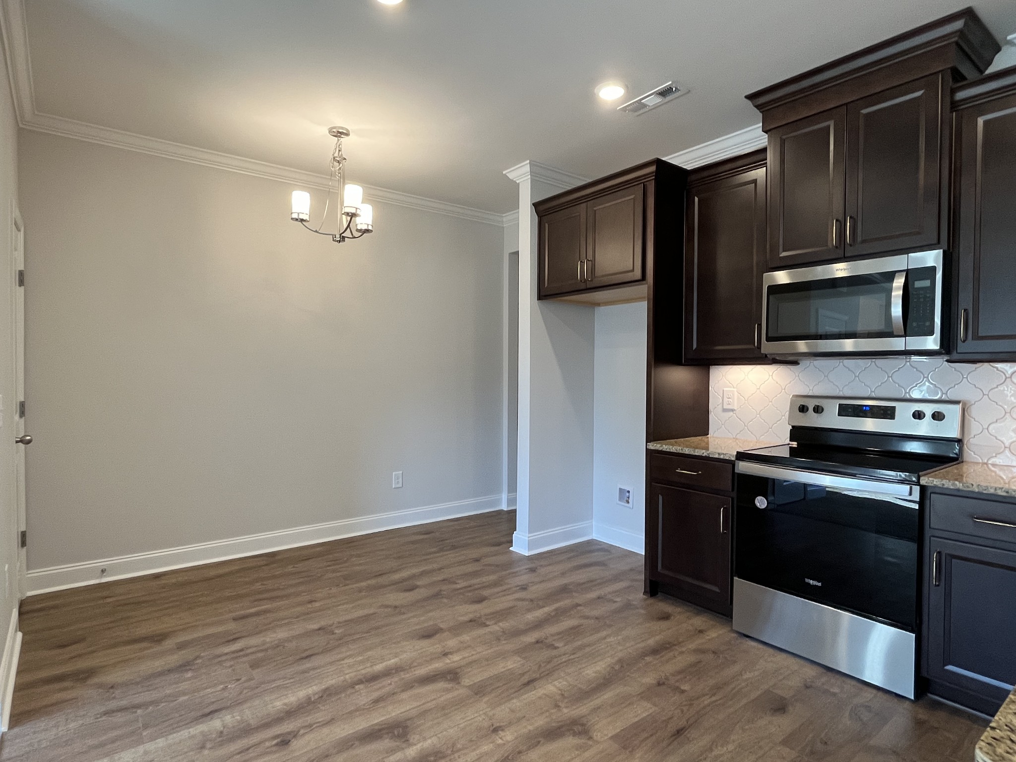 3267 Tasker Drive Antioch, TN 37013 - Photo 8 of 44 a kitchen with stainless steel appliances granite countertop a refrigerator microwave and stove
