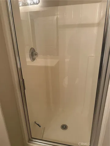 a bathroom with a glass shower door
