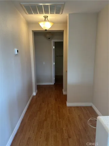 a view of a room with wooden floor