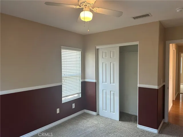an empty room with windows and closet