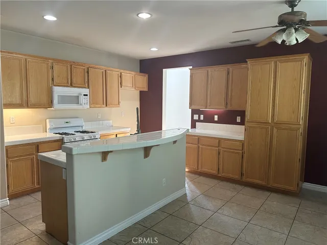 a kitchen with a refrigerator sink and cabinets