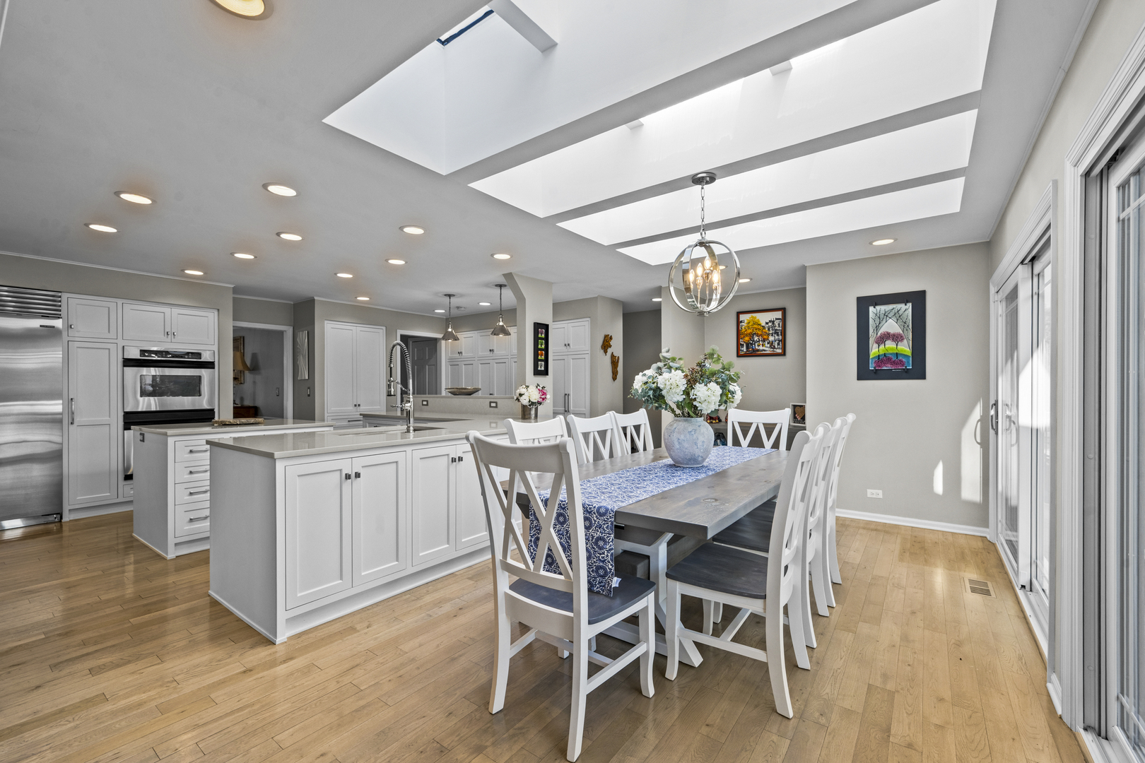 49 Green Bay Road Lake Bluff, IL 60044 - Photo 2 of 2 a kitchen with stainless steel appliances kitchen island granite countertop a table chairs sink and cabinets