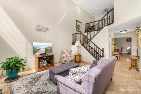 a living room with furniture potted plant and a rug