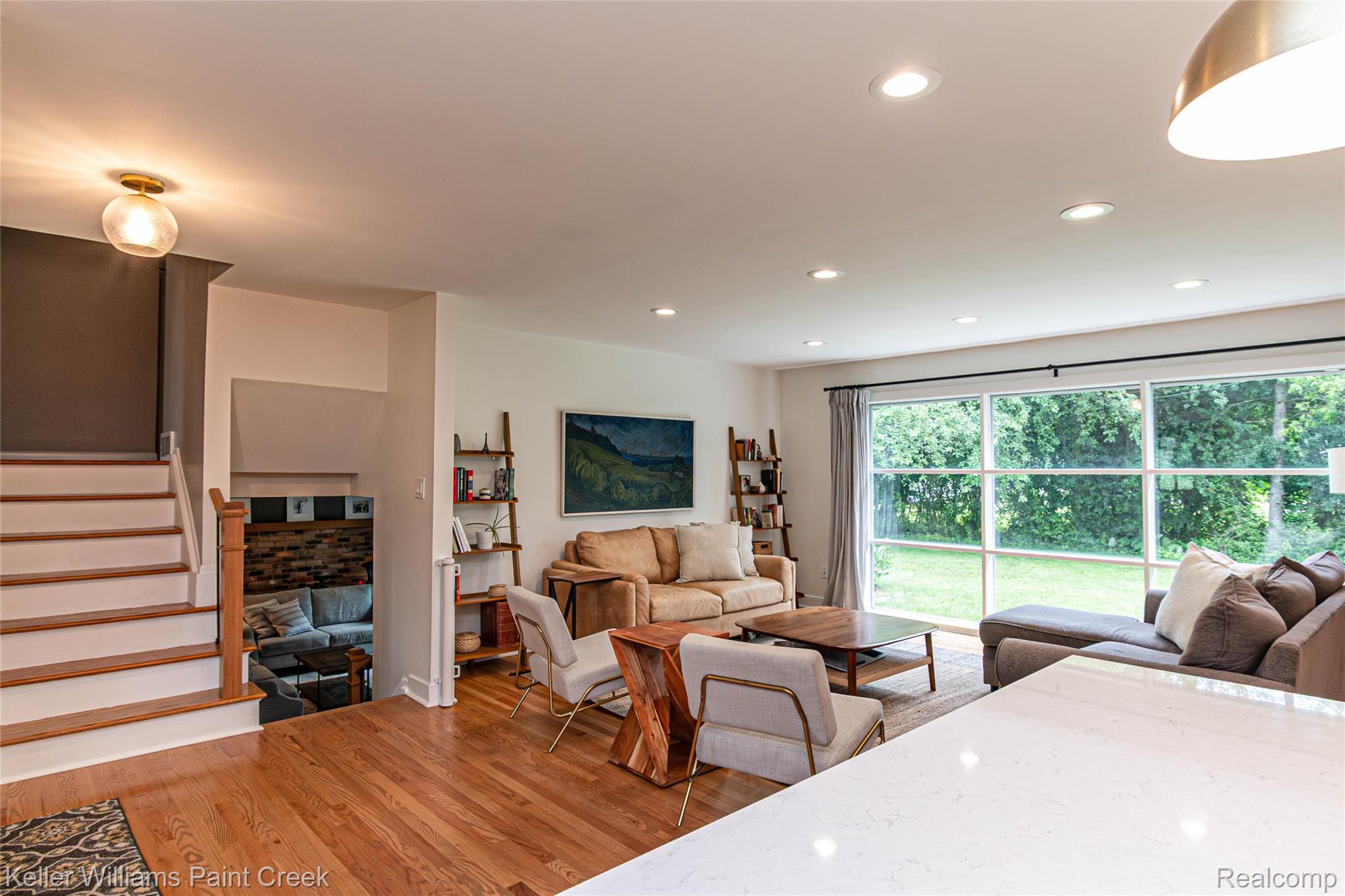 7093 Stonebrook Road West Bloomfield, MI 48322 - Photo 13 of 64 Living area featuring wood-finish flooring, recessed lighting, and a full-wall window overlooking exterior greenery