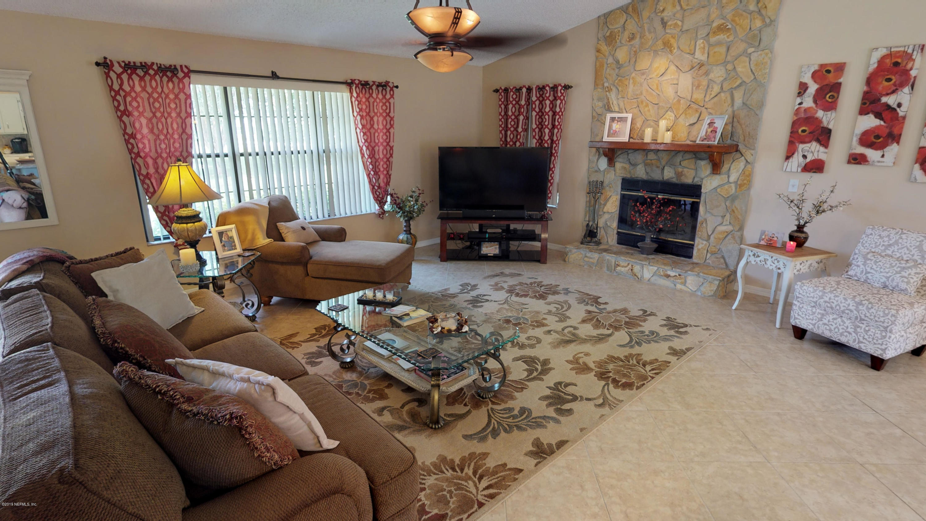 5175 Scaff Road St. Augustine, FL 32092 - Photo 13 of 20 a living room with furniture a fireplace and a flat screen tv