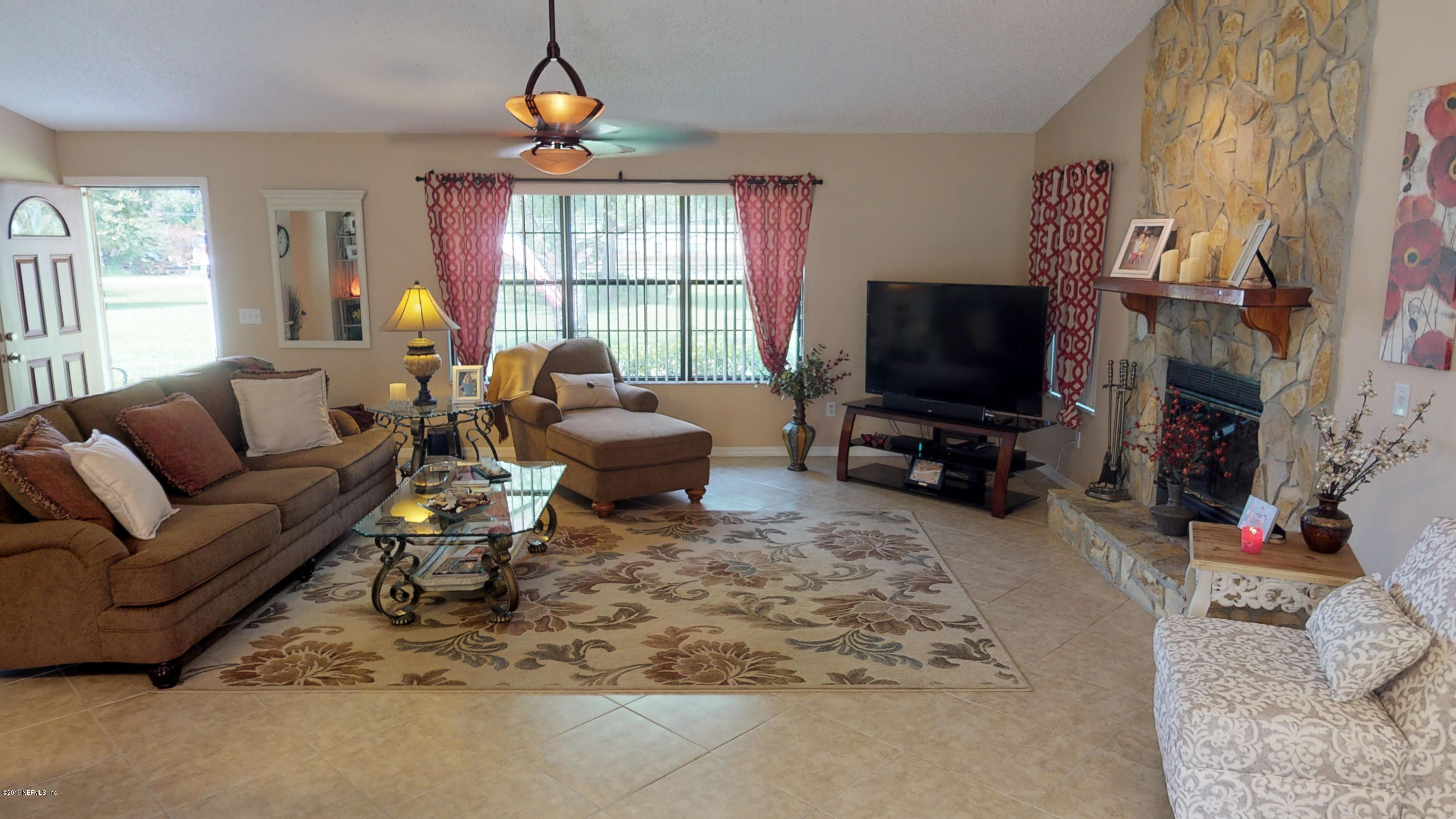 5175 Scaff Road St. Augustine, FL 32092 - Photo 14 of 20 a living room with furniture a window and a flat screen tv