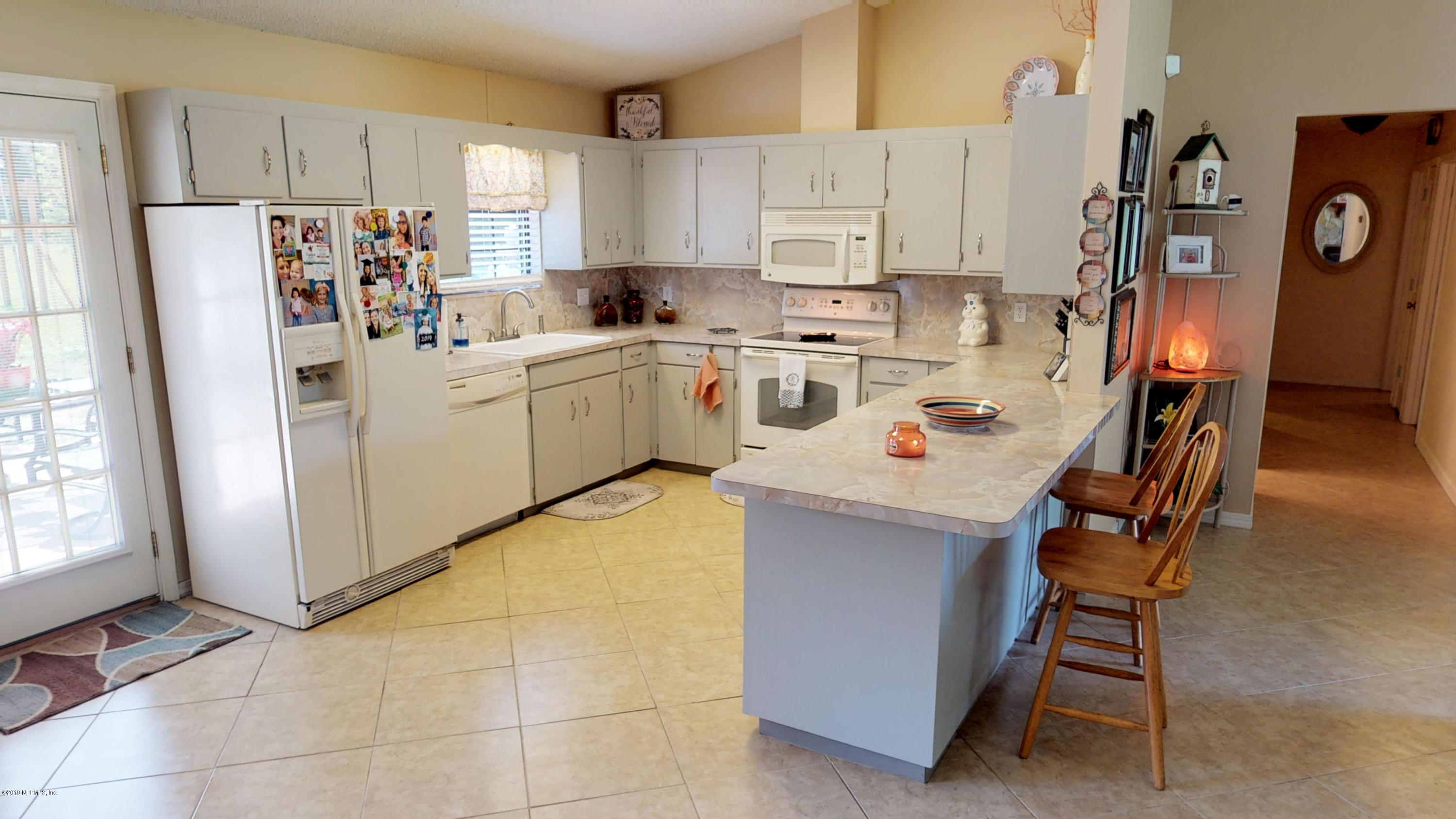 5175 Scaff Road St. Augustine, FL 32092 - Photo 16 of 20 a kitchen with stainless steel appliances a refrigerator sink and cabinets