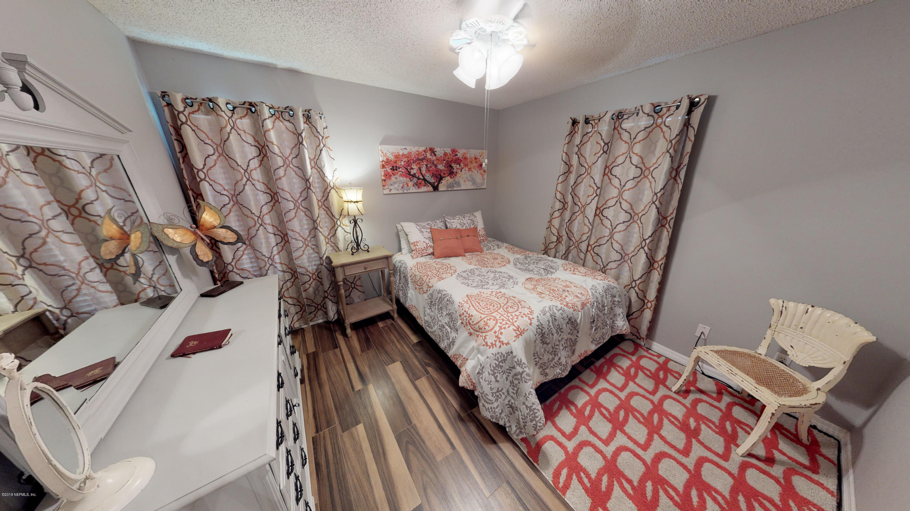 5175 Scaff Road St. Augustine, FL 32092 - Photo 18 of 20 a bedroom with a bed and a table