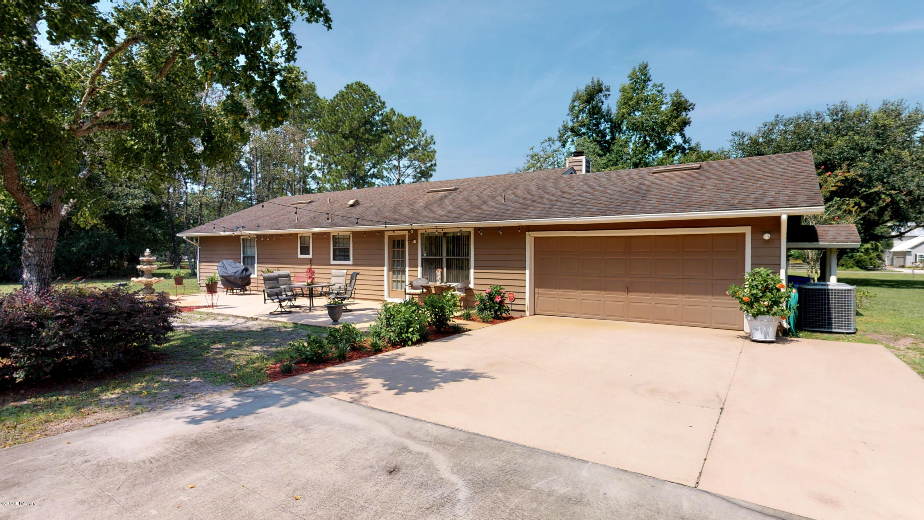 5175 Scaff Road St. Augustine, FL 32092 - Photo 2 of 20 a front view of a house with a garden and patio