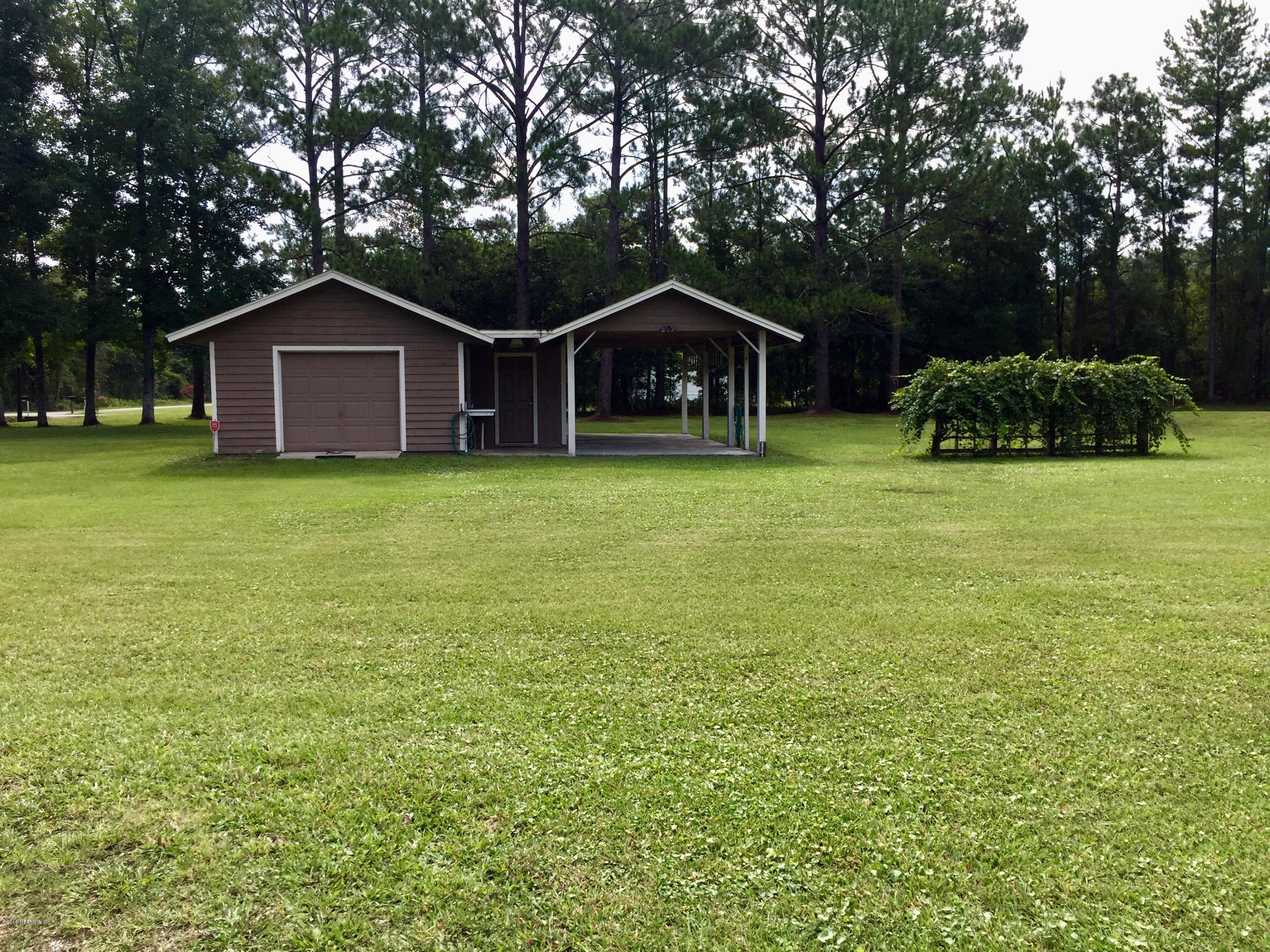 5175 Scaff Road St. Augustine, FL 32092 - Photo 4 of 20 a wooden house with a yard