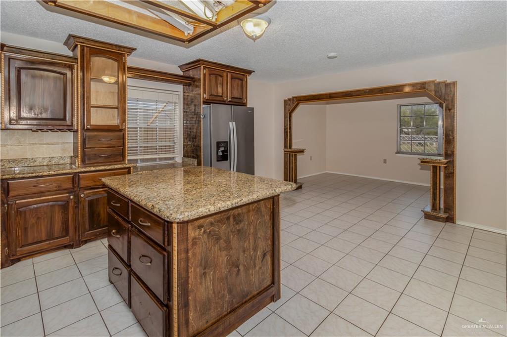207 East Saenz Avenue Pharr, TX 78577 - Photo 15 of 21 a kitchen with stainless steel appliances granite countertop a sink and cabinets