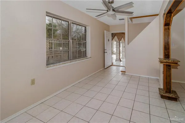 a view of a livingroom with an empty space and a window