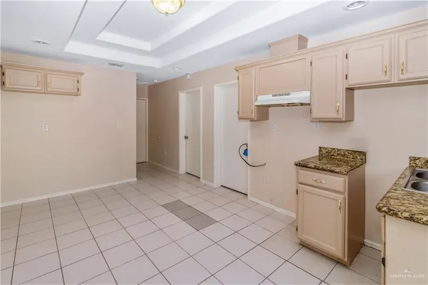 a kitchen with white cabinets and white appliances