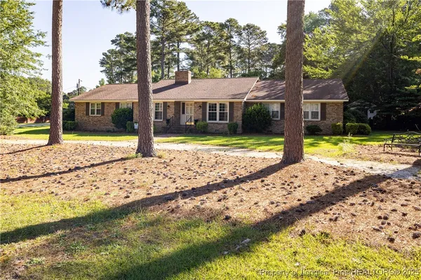 a view of a house with a yard covered in snow