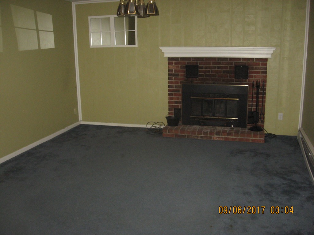 131 Dudley Road Templeton, MA 01468 - Photo 4 of 8 a view of an empty room with a fireplace