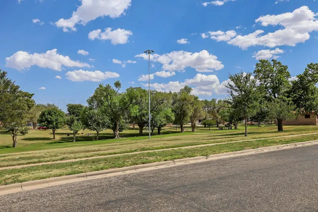 a view of a golf course with a big yard