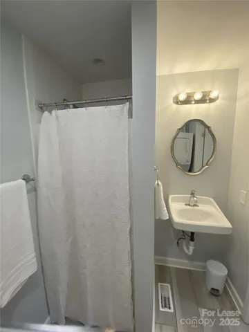 a bathroom with a sink toilet and a mirror