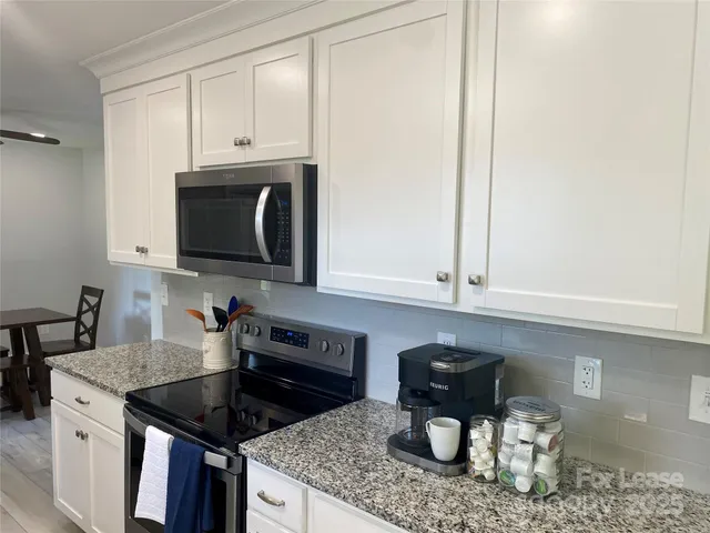 a kitchen with a stove and a microwave