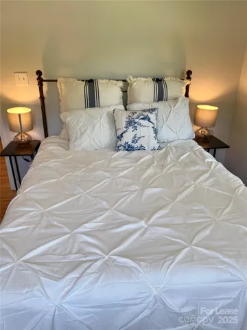 a bedroom with a bed and a night stand