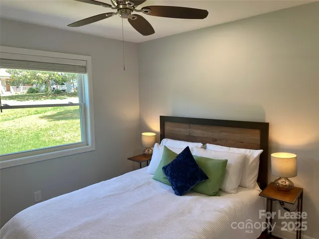 a bed room with a bed and a chair