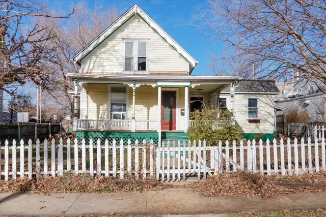 a front view of a house with a small yard