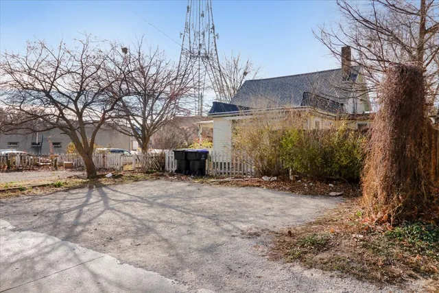 a backyard of a house with fire pit and trees