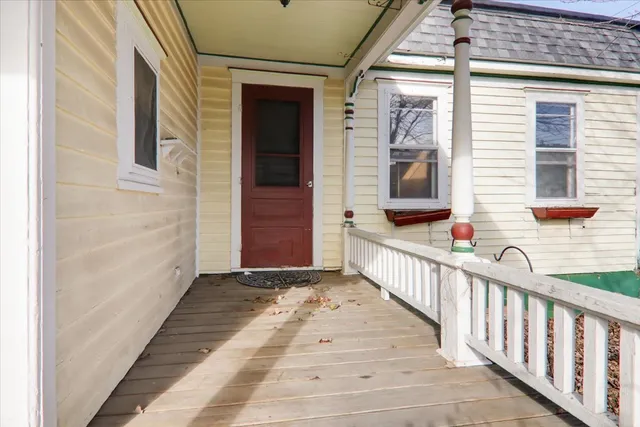 a view of a porch with wooden floor and stairs