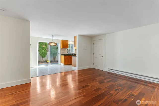 a view of a livingroom with wooden floor and a large window
