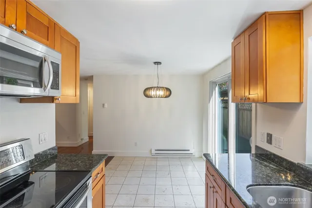 a kitchen with a sink refrigerator and cabinets