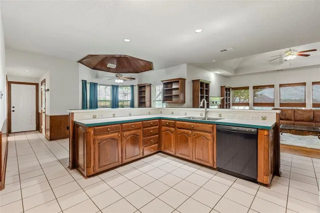 a kitchen with stainless steel appliances granite countertop a sink and cabinets