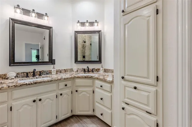 a bathroom with a double vanity sink and a mirror