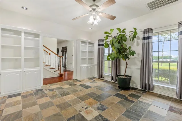 a bedroom with furniture and a potted plant