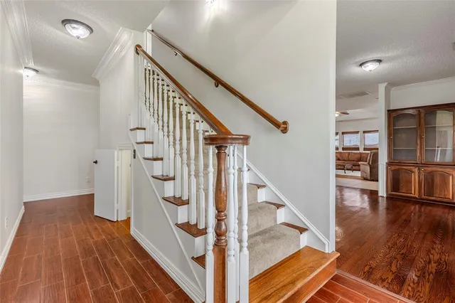 a view of entryway with wooden floor and stairs