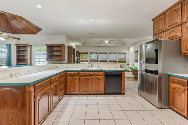 a kitchen with stainless steel appliances granite countertop a sink and cabinets