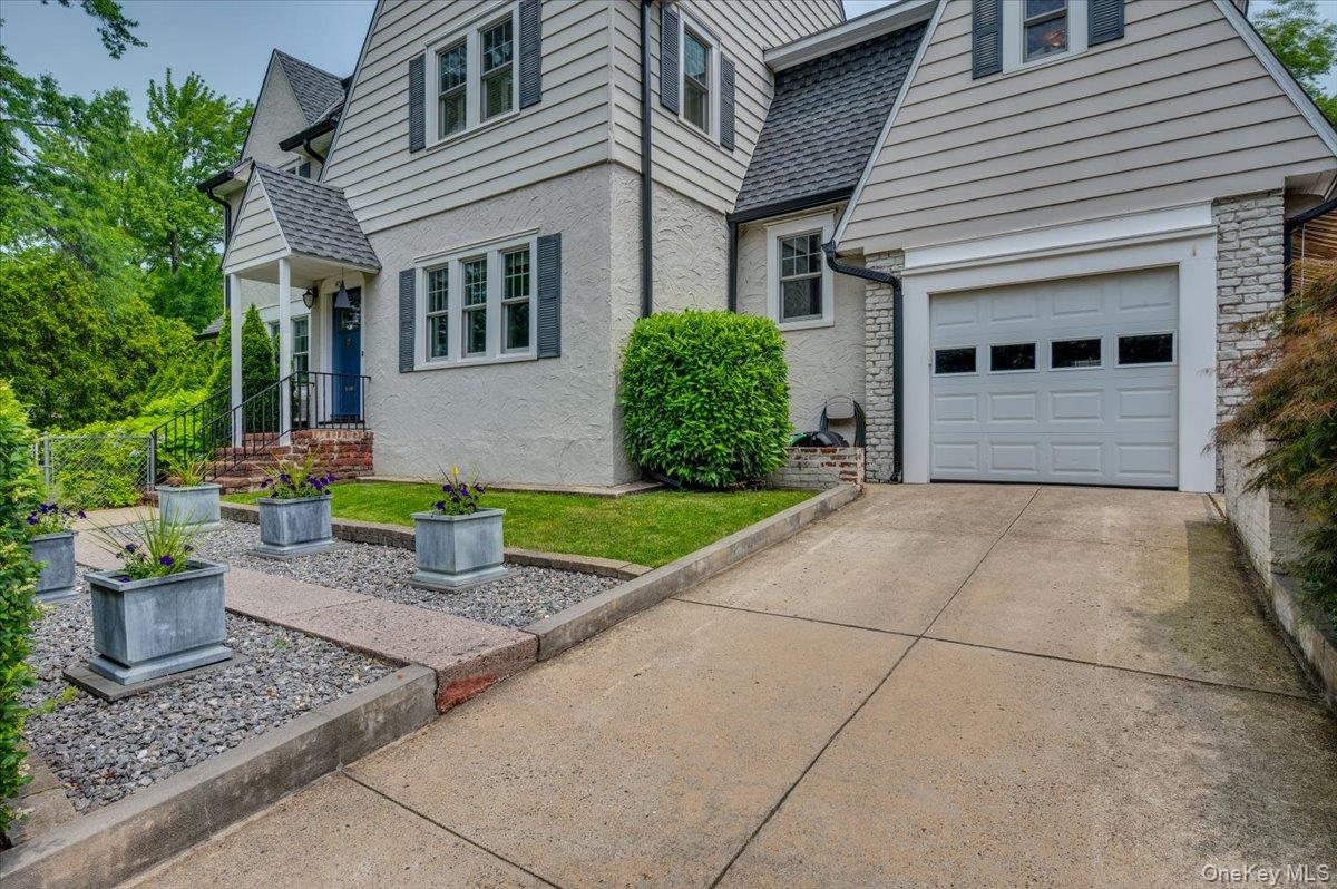 400 Manor Ridge Road Pelham, NY 10803 - Photo 34 of 39 a front view of a house with a garden