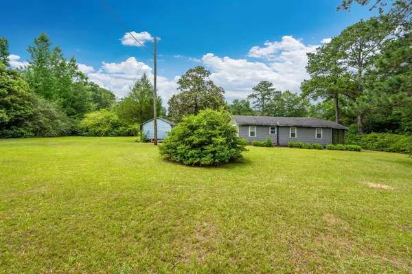 a front view of house with yard and trees