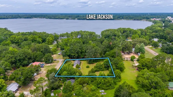 an aerial view of a house with a yard