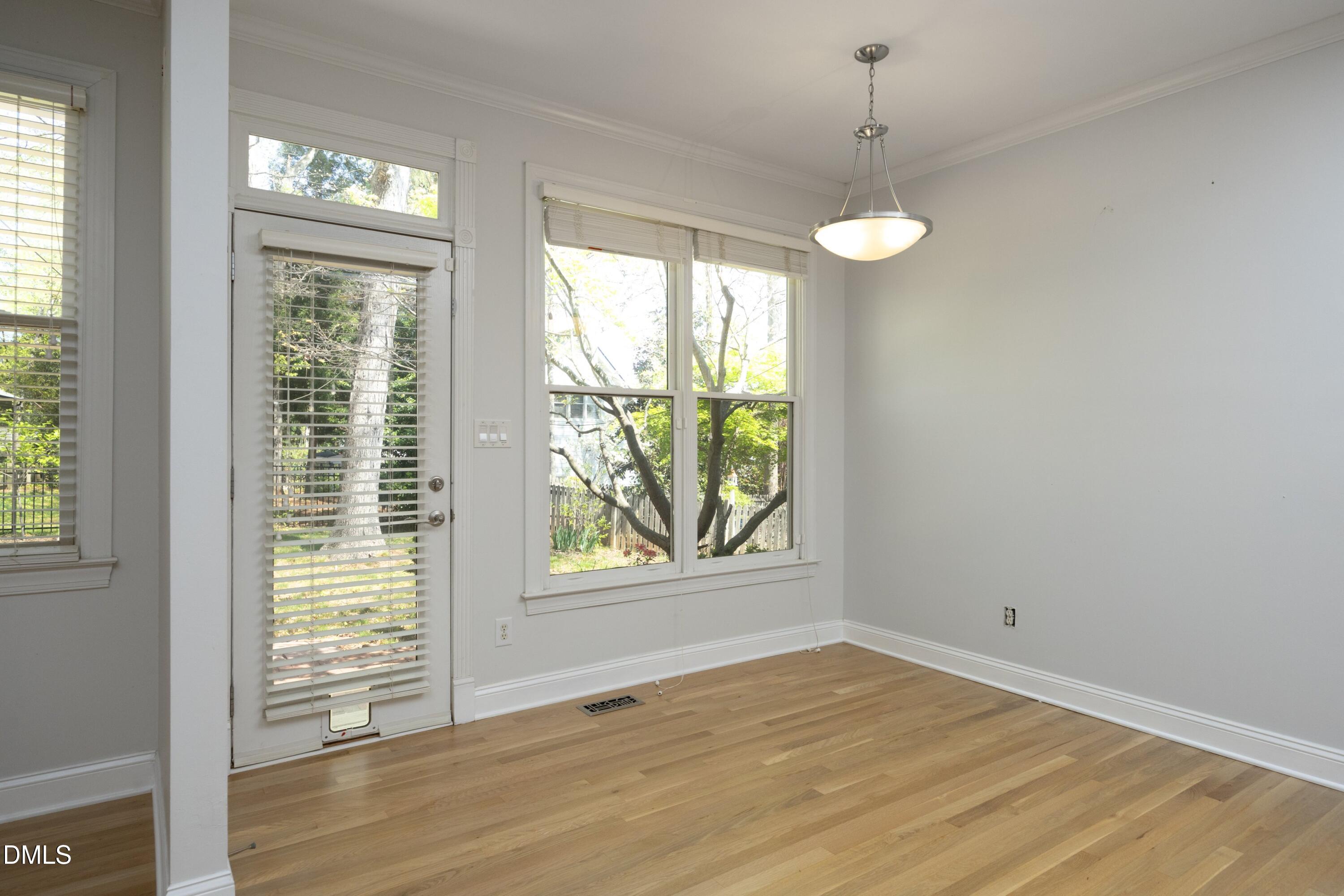 1427 Moosecreek Drive Raleigh, NC 27614 - Photo 19 of 51 a view of an empty room with wooden floor and a window