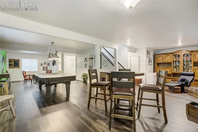 a view of a dining room with furniture and wooden floor