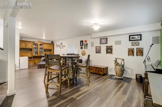 a dining room with furniture and wooden floor