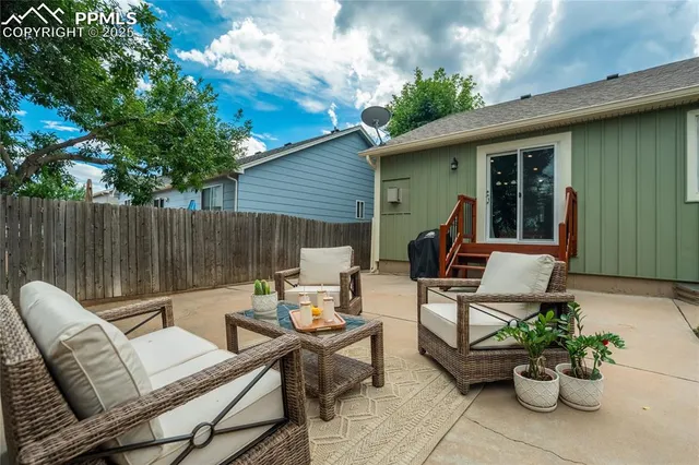 a view of a patio with couple of chairs