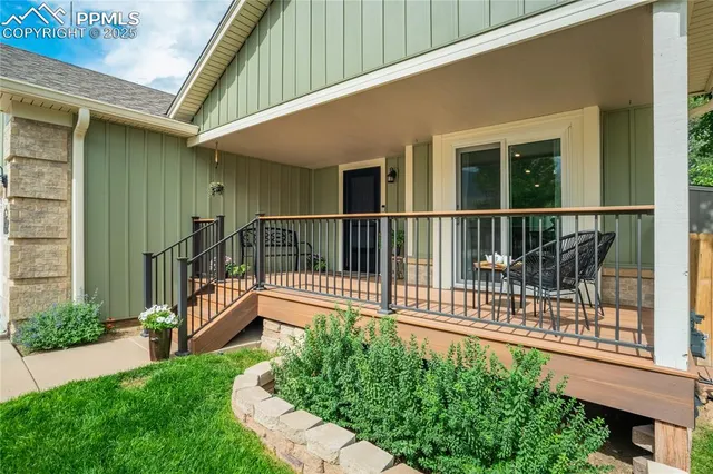 a view of a house with a small yard and wooden fence