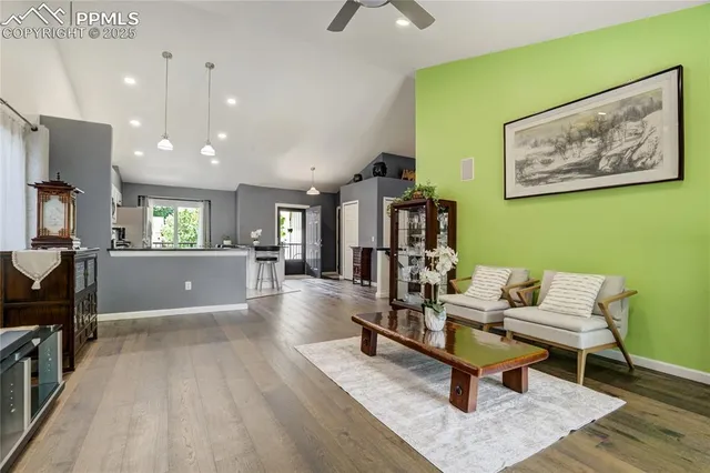 a living room with furniture and a wooden floor
